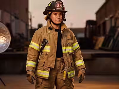 Bombero con traje estructural certificado NFPA 1971 — ensemble completo de calidad profesional